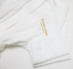 White robe with 'Yahweh Homes' embroidery on a white background