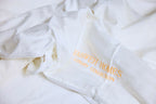 White Duvet cover with a zipper and  Yahweh Homes Luxury collection inscribed on it.